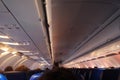 Interior of airplane with passengers on seats waiting to taik of