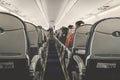 Interior of airplane with passengers on seats waiting to taik off.