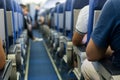 Interior of airplane with passengers on seats waiting to taik of