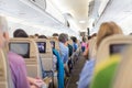 Interior of airplane with passengers on seats waiting to taik off.