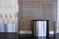 Interior of airport toilet. Metal garbage bin close up Royalty Free Stock Photo