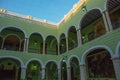 Interior with arches, paintings and green walls. City Town hall of Yucatan in Mexico. Merida. Royalty Free Stock Photo