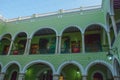 Interior with arches, paintings and green walls. City Town hall of Yucatan in Mexico. Merida. Royalty Free Stock Photo