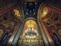 Interior architectural details of the Curtea de Arges monastery. The tall hall with painted icons, the golden altar and a Royalty Free Stock Photo