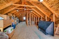 Interior of the attic of house with boxes and old appliances under gable roof Royalty Free Stock Photo