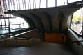 Entryway covered by concrete canopy ceiling with exposed beams over entrance stairway on inside of Sydney Opera House, Australia