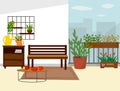The interior of the balcony is a sofa, a tea table and a chest of drawers with flowers. Royalty Free Stock Photo