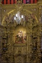 Interior of a baroque church decorated with images of saints and walls with gold leaf ornaments Royalty Free Stock Photo