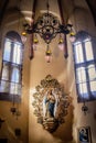 Interior of basilica of San Francesco with vintage lamps and statue of the Virgin Mary in a niche, Bologna ITALY Royalty Free Stock Photo