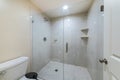 Interior of a bathroom with frameless shower stall