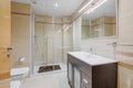 Interior of a bathroom in light tones with shower cabin, toilet and sink. Royalty Free Stock Photo