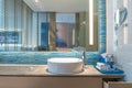 Interior of bathroom with sink basin faucet and mirror. Modern d