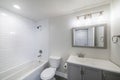 Interior of a bathroom with vanity sink and shower tub combo with subway tiles wall surround