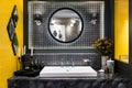 Interior of bathroom with washbasin faucet and black towel.