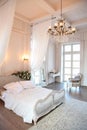 The interior of a beautiful bedroom Suite in bright white. Royalty Free Stock Photo