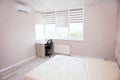 Interior of bedroom after being renovated. Room in bright colors with new renovation. Large bed, air conditioning and computer Royalty Free Stock Photo