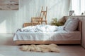 Interior of bedroom with cozy bed, pillows, blanket, pictures and easel.