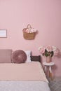 Interior bedroom furniture concept. Cozy Pink Bedroom corner. Cozy, feminine bedroom with pink bed, decorative cushions and plant Royalty Free Stock Photo