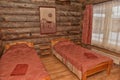 Interior of a bedroom with several beds, walls made of wood Royalty Free Stock Photo