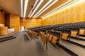 Interior of big conference hall full of gray folding chairs