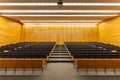 Interior of big conference hall full of gray folding chairs