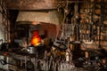 Interior of Blacksmith forge with tools hanging on wall and anvil and hammer ready to be used. Furnace formant Royalty Free Stock Photo