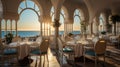 Interior with blue chairs of a chic restaurant on the Mediterranean coast. The tables are elegantly set for receiving