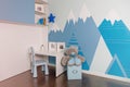 The interior of the boy's room in blue colors, mountains on the walls. Realistic. Royalty Free Stock Photo