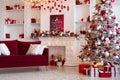 Interior of bright modern living room with fireplace, chandelier and comfortable sofa decorated with Christmas tree and Royalty Free Stock Photo