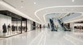 Interior of a bright, modern shopping mall with escalators and storefronts spacious Royalty Free Stock Photo
