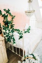 Interior of bright white bedroom with decorative flowers on a wall Royalty Free Stock Photo