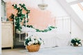 Interior of bright white bedroom with decorative flowers on a wall Royalty Free Stock Photo