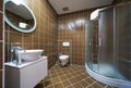 Interior of brown bathroom with bathtub, sink and toilet