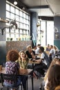 Interior Of Busy Coffee Shop With Customers Sitting At Tables Royalty Free Stock Photo