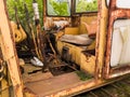 Interior of cabin with lever, joystick and seat of abandoned deserted old rusty bulldozer, vintage industrial heavy machine,