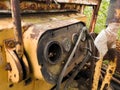 Interior of cabin with levers and instruments panel of abandoned deserted old rusty bulldozer, vintage industrial heavy machine,