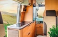 Interior of a camper van with kitchen and bed
