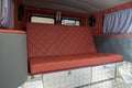 The interior of the car in the back of a van converted into a motor home for off-road and travel with a brown leather interior, a