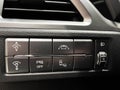 The interior of the car. Buttons for adjusting the height of the headlights, turning off the ESP, distance, dead zone Royalty Free Stock Photo