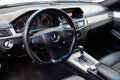 The interior of the car Mercedes Benz E-class E250 with a view of the steering wheel, dashboard, seats and multimedia system with Royalty Free Stock Photo