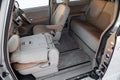 The interior of the car Toyota Porte in the back of a minivan with a wide open door and a view of the control panel, steering Royalty Free Stock Photo