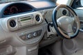 The interior of the car Toyota Porte in the back of a minivan with a wide open door and a view of the control panel, steering Royalty Free Stock Photo