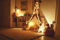 Interior of children`s playroom with tent, lamps and toys in dar Royalty Free Stock Photo