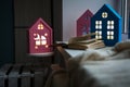The interior of the children`s room, cozy night lights in the form of houses on the window glow yellow. Royalty Free Stock Photo