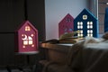 The interior of the children`s room, cozy night lights in the form of houses on the window glow yellow. Royalty Free Stock Photo