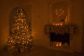 Interior Christmas background with illuminations magic glowing tree, fireplace and gifts in dark night Royalty Free Stock Photo