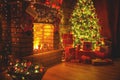 Interior christmas. Magic glowing tree, fireplace gifts in dark