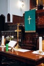 Interior of a church altar with golden cross, holy bible and candles on it Royalty Free Stock Photo