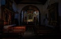 Interior of the Church of Saint Pete in Vilaflor with the altar and benches in dark tones Royalty Free Stock Photo