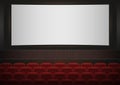 Interior of a cinema movie theatre. Red cinema or theater seats in front of white blank screen. Empty Cinema auditorium Royalty Free Stock Photo